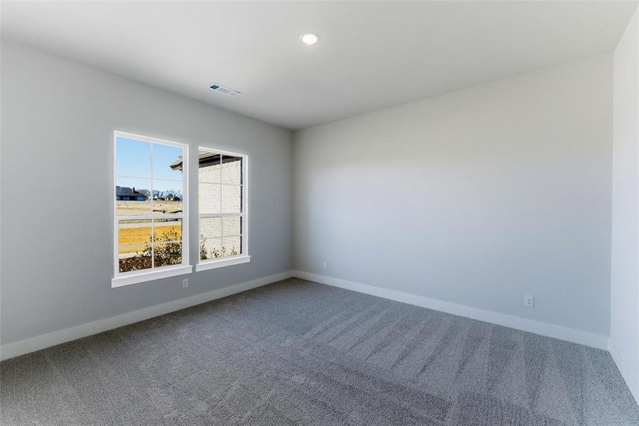 Carpeted empty room featuring baseboards and recessed lighting
