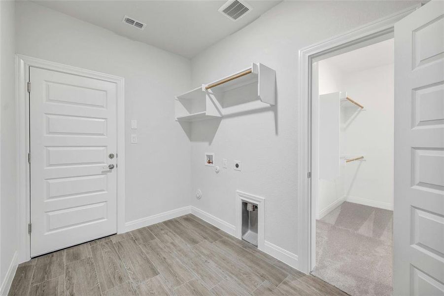 Utility room that connects to the master bedroom closet