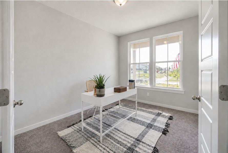 Double windows fill this versatile room with natural light across neutral carpeting. Double windows fill this versatile room with natural light across neutral carpeting.