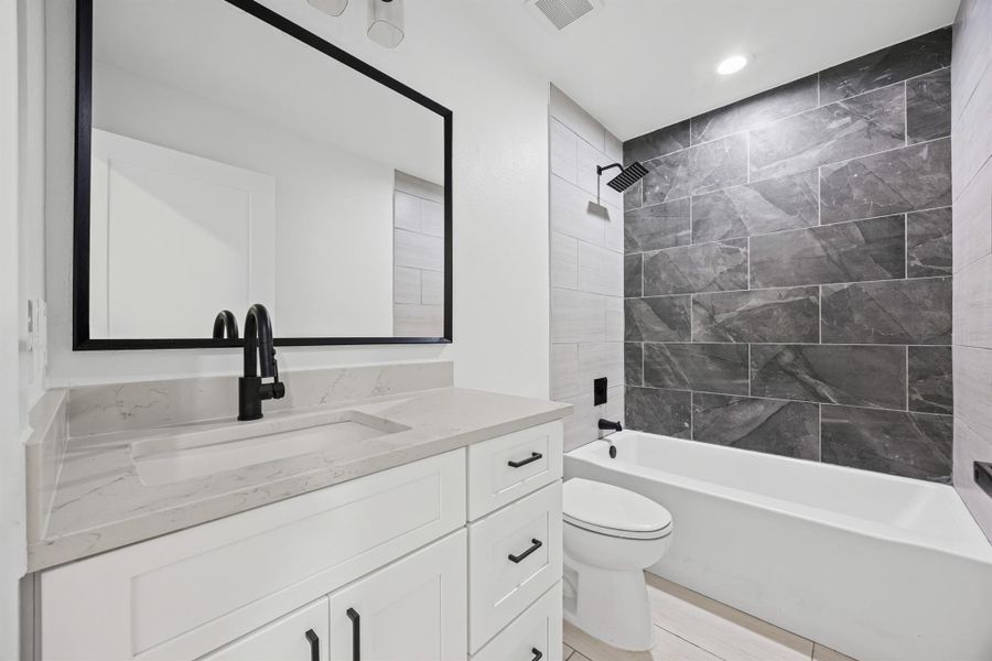 Bathroom with vanity, shower / washtub combination, and recessed lighting
