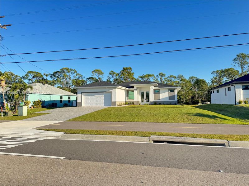 Front exterior of a new home in , Cape Coral, FL, highlighting curb appeal (Image 12).