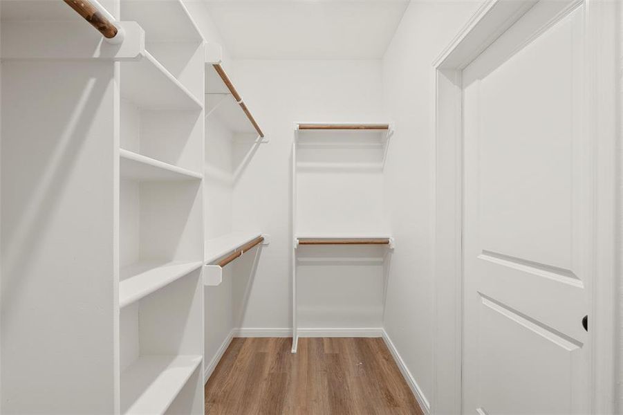 Spacious closet featuring light wood-type flooring Spacious closet featuring light wood-type flooring