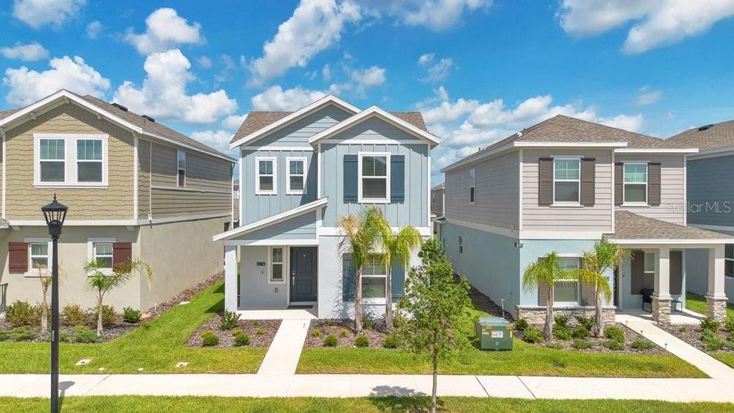 Front exterior of a new home in Wellness Ridge, Clermont, FL, highlighting curb appeal (Image 23).