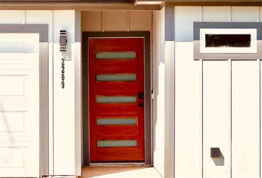 Wood front door with video ringbell.