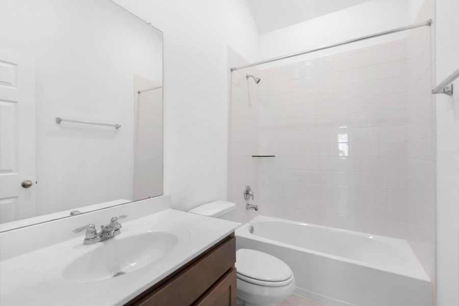 The secondary bath features tile flooring, white cabinetry and light countertops and a shower/tub combo. Perfect for accommodating any visiting family and friends. The secondary bath features tile flooring, white cabinetry and light countertops and a shower/tub combo. Perfect for accommodating any visiting family and friends.