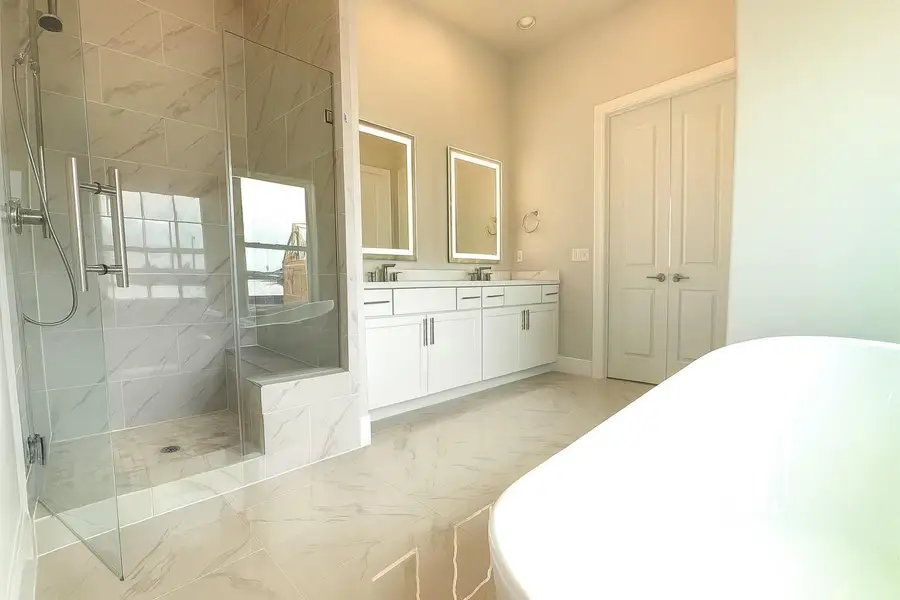 Separate shower and tub in the primary bathroom.