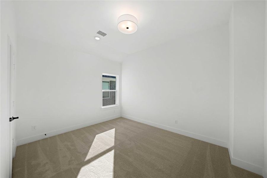 Spare room with carpet floors and vaulted ceiling Spare room with carpet floors and vaulted ceiling