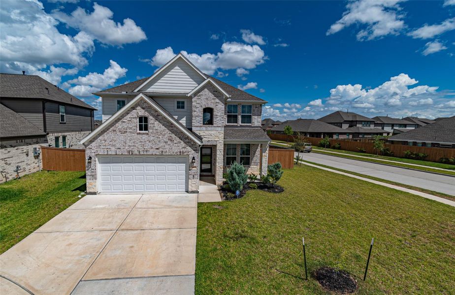 Front exterior of a new home in Marvida, Cypress, TX, highlighting curb appeal (Image 1). Front exterior of a new home in Marvida, Cypress, TX, highlighting curb appeal (Image 1).
