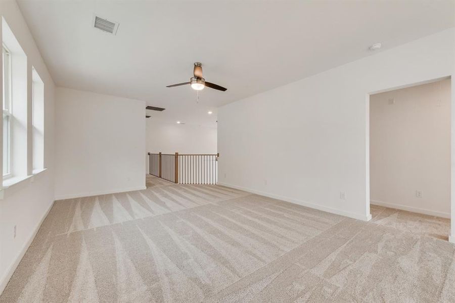 Unfurnished room featuring light carpet and baseboards Unfurnished room featuring light carpet and baseboards