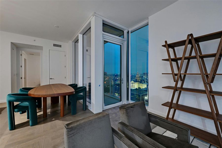 The dining area offers a perfect setting to enjoy meals while soaking in the breathtaking panoramic city view. Furnishings provided by Scott + Cooner available for purchase separately. Photo is model unit #2406.