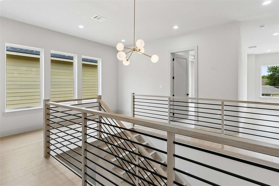 Stairs lead to the second level are true wood floors with iron rails and decorative chandelier. Stairs lead to the second level are true wood floors with iron rails and decorative chandelier.