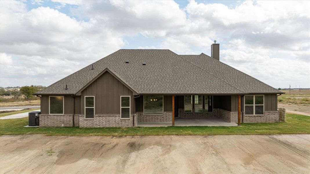 Rear view of house with central air condition unit and a patio