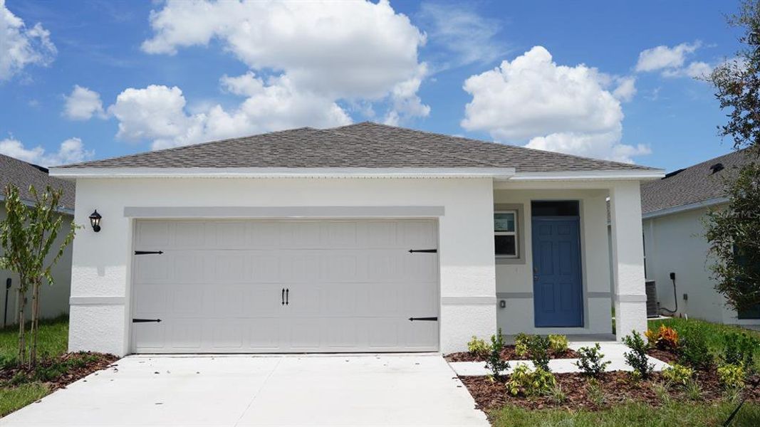 Front exterior of a new home in , Winter Haven, FL, highlighting curb appeal (Image 1). Front exterior of a new home in , Winter Haven, FL, highlighting curb appeal (Image 1).