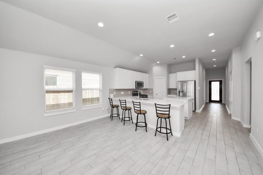 Open dining area with plenty of space for a full-size table, highlighted by large windows that fill the room with natural light and enhance the airy layout.