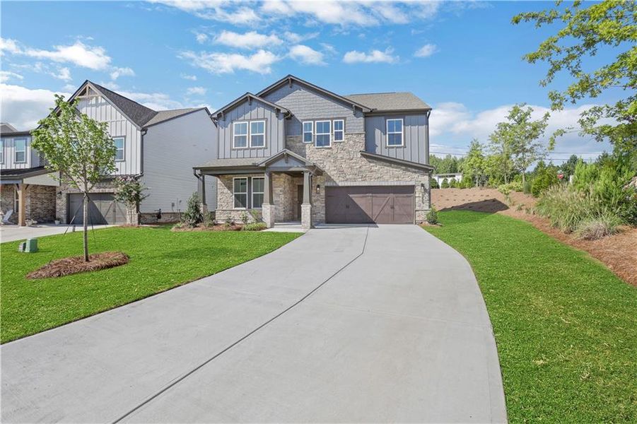 Front exterior of a new home in The Paddocks at Doc Hughes, Buford, GA, highlighting curb appeal (Image 25).
