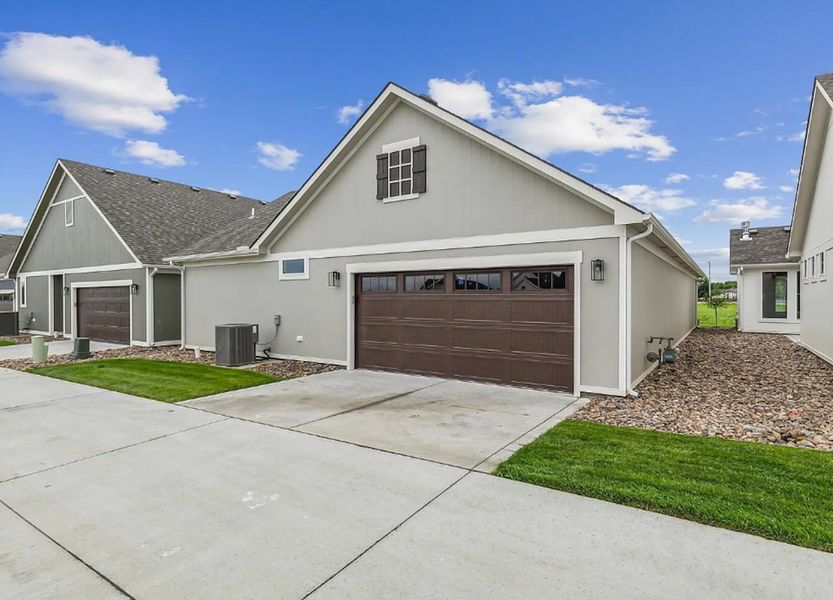 Front exterior of a new home in The Courtyards at Cornerstone, Andover, KS, highlighting curb appeal (Image 2). Front exterior of a new home in The Courtyards at Cornerstone, Andover, KS, highlighting curb appeal (Image 2).