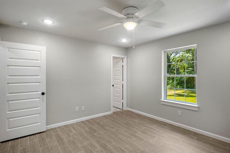 Unfurnished bedroom featuring recessed lighting, a spacious closet, a ceiling fan, and light wood-type flooring Unfurnished bedroom featuring recessed lighting, a spacious closet, a ceiling fan, and light wood-type flooring