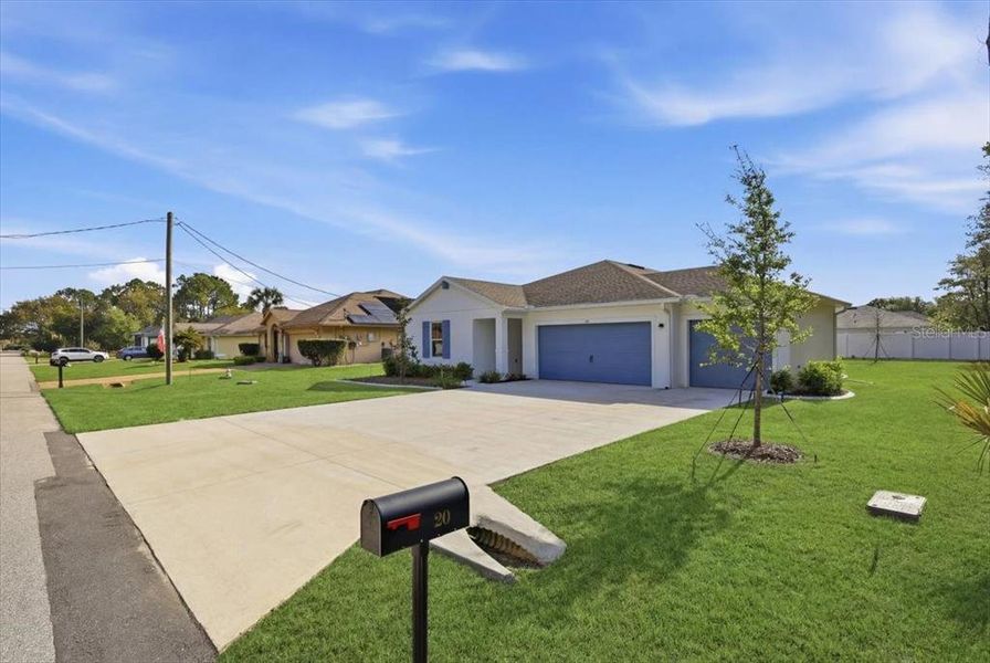 Front exterior of a new home in Aspire at Palm Coast, Palm Coast, FL, highlighting curb appeal (Image 27).