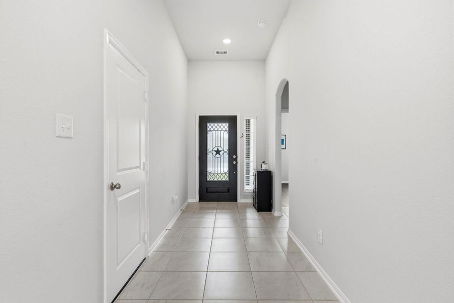A long, elegant hallway creates the perfect first impression with airy spaces and timeless design throughout. A long, elegant hallway creates the perfect first impression with airy spaces and timeless design throughout.
