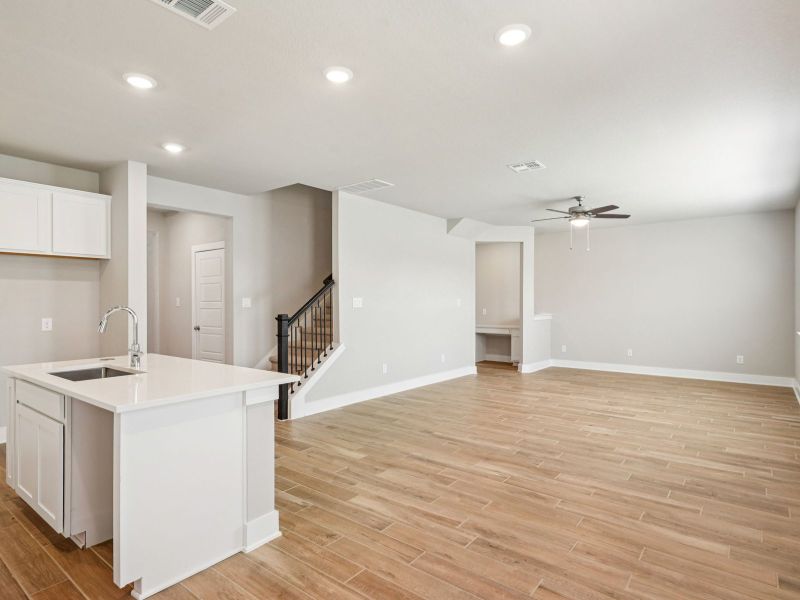 Kitchen and living room in the Red River floorplan at a Meritage Homes community.