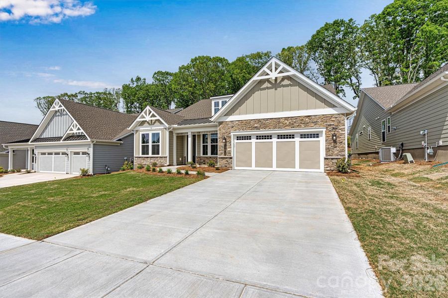 Front exterior of a new home in Cresswind Charlotte, Charlotte, NC, highlighting curb appeal (Image 19).