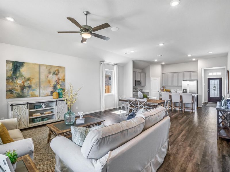 Gather the family and guests together in your lovely living room! Featuring soaring high ceilings, recessed lighting, ceiling fan, custom paint, gorgeous floors, and large windows that provide plenty of natural lighting throughout the day. Sample photo of completed home with similar floor plan. As-built interior colors and selections may vary. Gather the family and guests together in your lovely living room! Featuring soaring high ceilings, recessed lighting, ceiling fan, custom paint, gorgeous floors, and large windows that provide plenty of natural lighting throughout the day. Sample photo of completed home with similar floor plan. As-built interior colors and selections may vary.