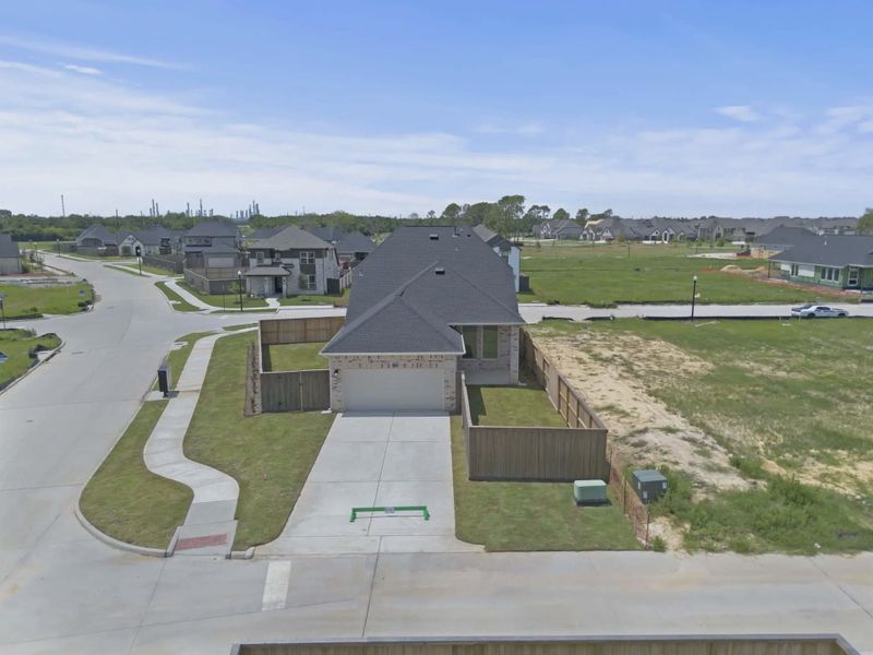 Representative exterior photo of a completed home built from the St Andrews by Chesmar Homes in Riceland Alley Loads, Mont Belvieu, TX (Image 30).