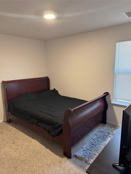 Carpeted bedroom with baseboards