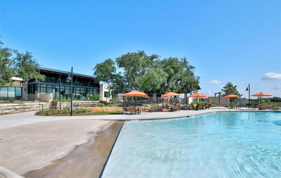 The pool offers excitement for all ages with a beach like entrance and several shaded tables and lounge chairs.