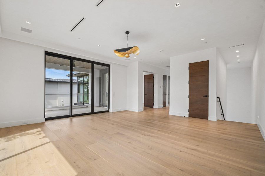 Rich wood flooring pairs beautifully with clean plaster walls and contemporary black-framed glass sliding doors. Rich wood flooring pairs beautifully with clean plaster walls and contemporary black-framed glass sliding doors.