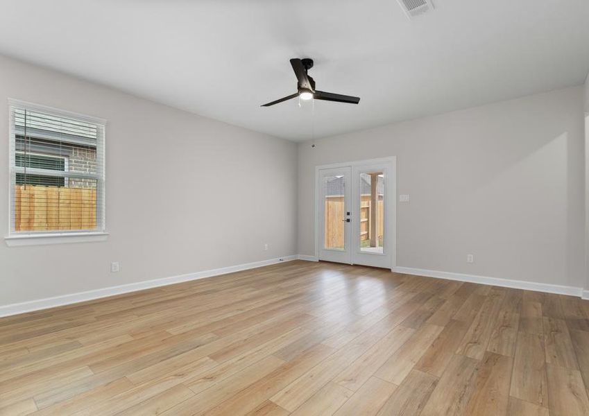 The kitchen and dining room feature a view of the backyard.