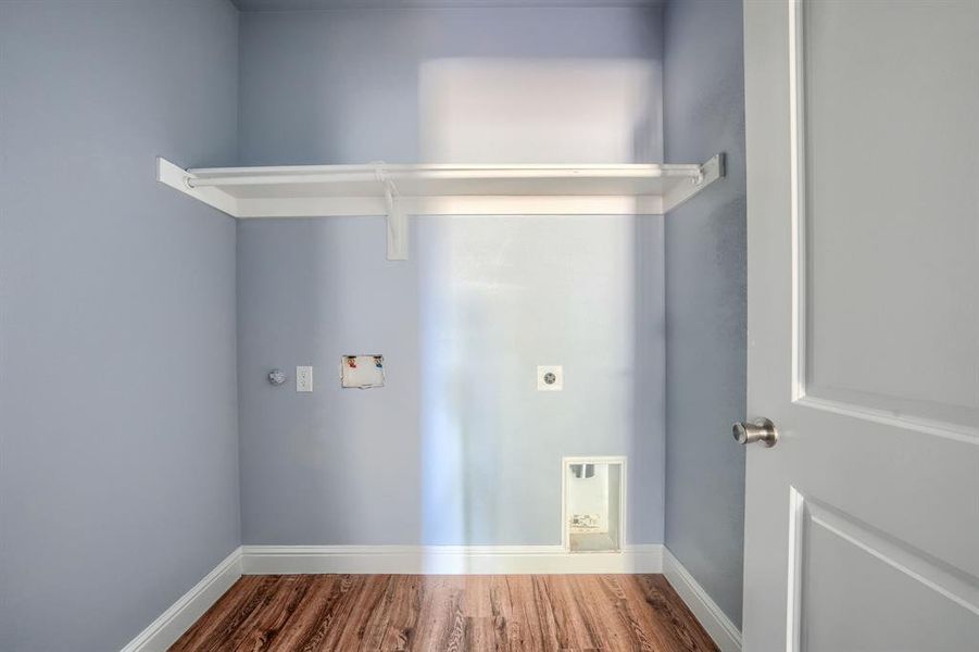 Laundry room featuring hookup for a washing machine, electric dryer hookup, and hardwood / wood-style floors