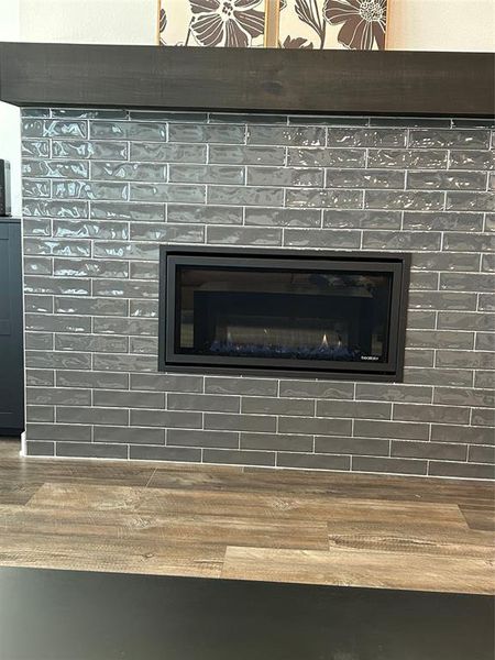 Detailed view of wood finished floors and a fireplace Detailed view of wood finished floors and a fireplace