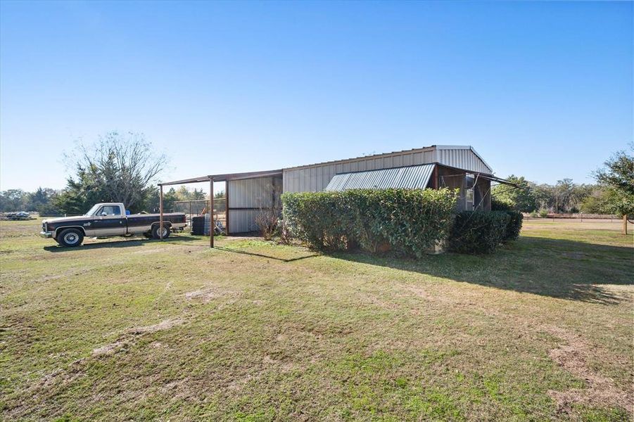 View of yard featuring a shed/carport and chicken coop View of yard featuring a shed/carport and chicken coop