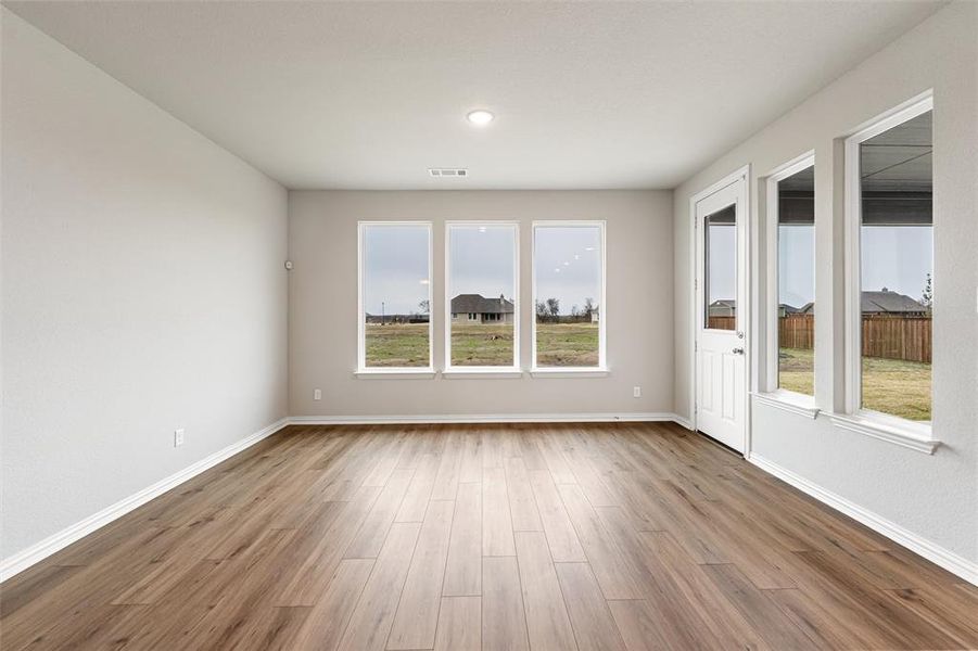 Spare room featuring light wood-style flooring and recessed lighting