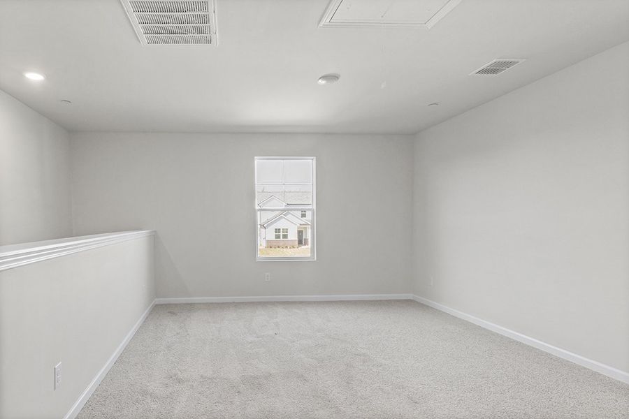 A room with a white wall and a painting on the wall. A room with a white wall and a painting on the wall.