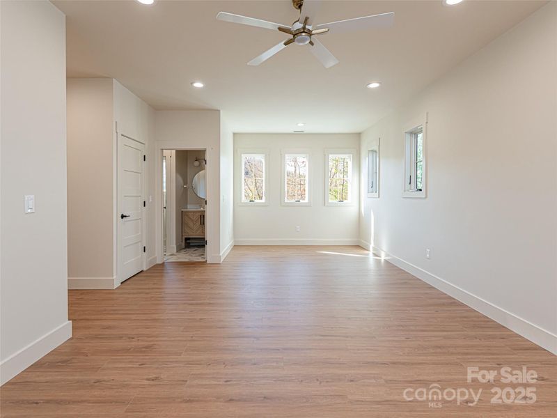 Can be utilized as an upper level primary suite, family room, or artist space.