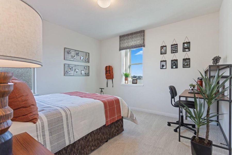 Secondary bedroom features plush carpet flooring, neutral paint, lighting, large windows, and an ample sized closet space.