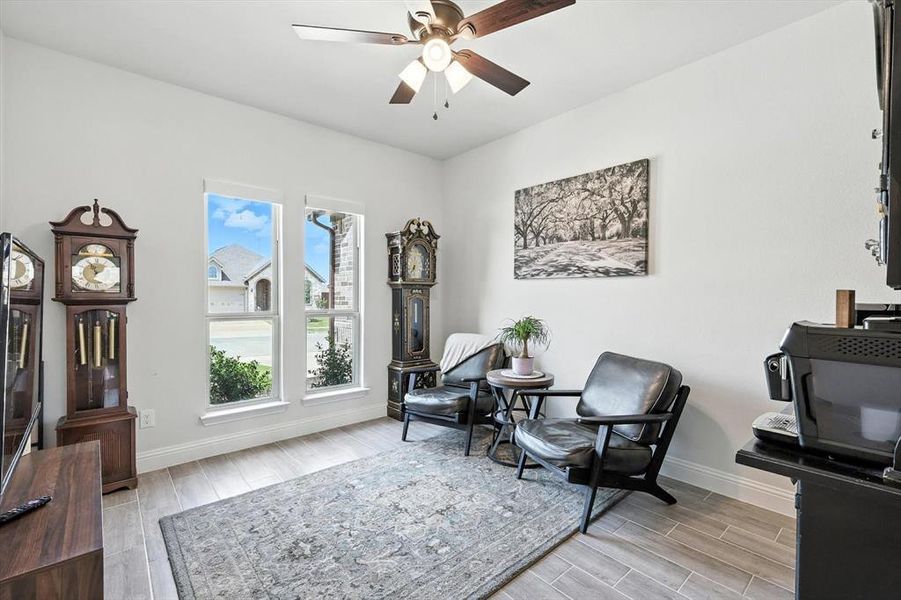 Sitting room with wood finish floors and ceiling fan