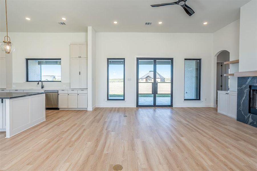 Kitchen featuring white cabinets, dishwasher, and light hardwood / wood-style floors