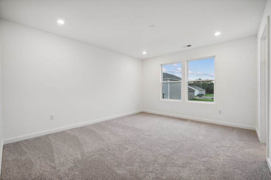 A room with a window and a carpet. A room with a window and a carpet.