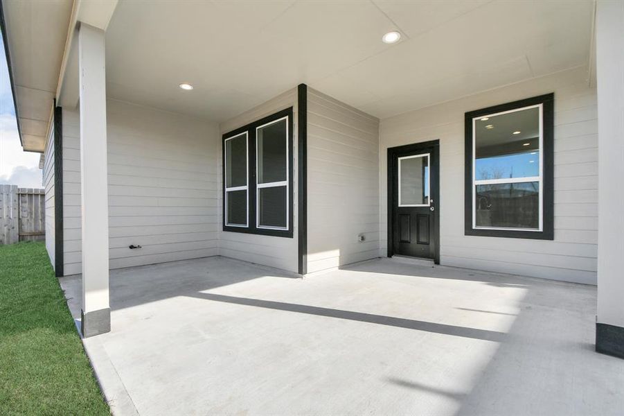 Discover the expansive backyard and its inviting covered patio. Sample photo of completed home with similar floor plan. As-built interior colors and selections may vary.