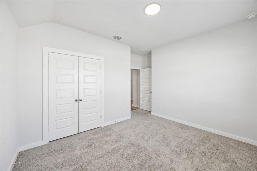 Bedroom in the Oscar home plan by Trophy Signature Homes – REPRESENTATIVE PHOTO