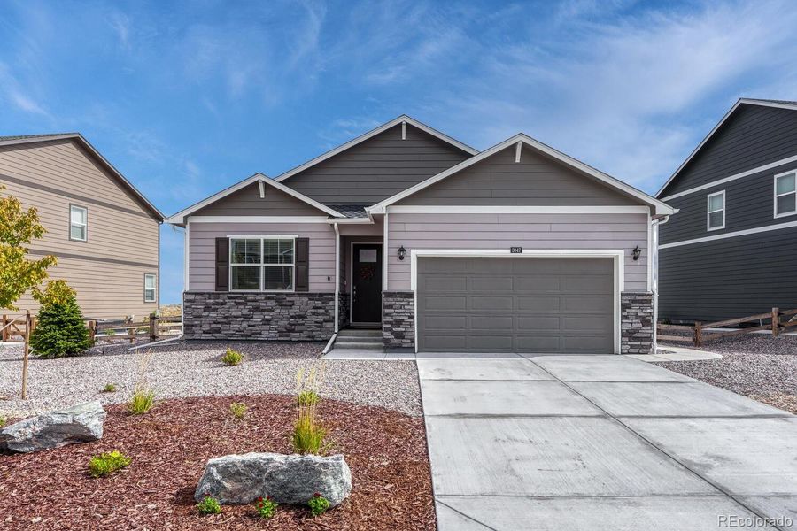 Front exterior of a new home in Spring Valley Ranch, Elizabeth, CO, highlighting curb appeal (Image 2).