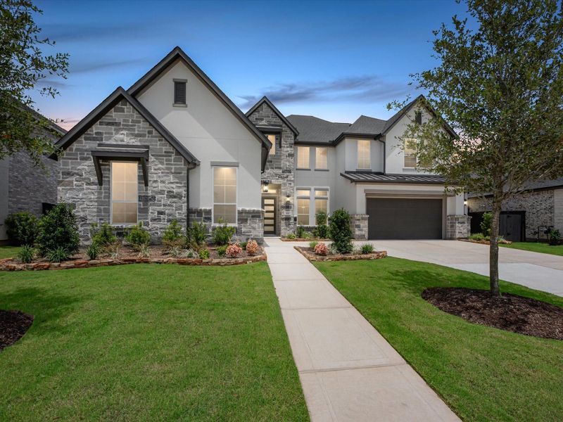 Front exterior of a new home in Harvest Green, Richmond, TX, highlighting curb appeal (Image 2). Front exterior of a new home in Harvest Green, Richmond, TX, highlighting curb appeal (Image 2).