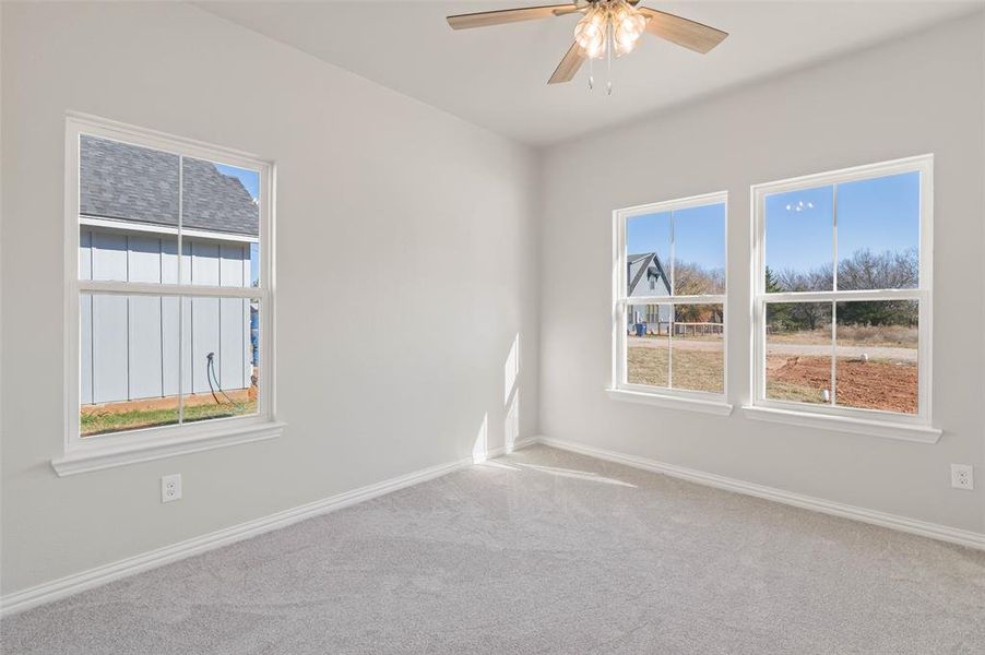Carpeted spare room with ceiling fan Carpeted spare room with ceiling fan