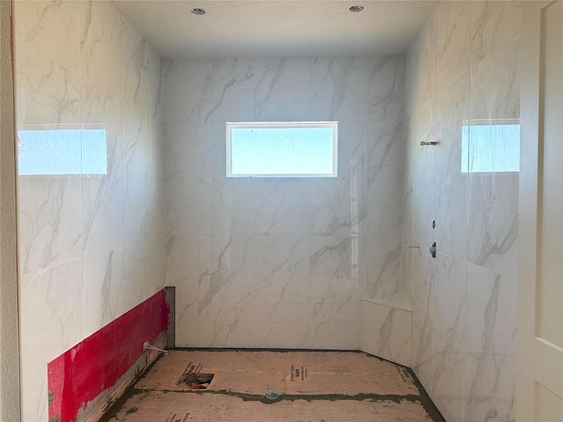 Bathroom featuring a marble finish shower
