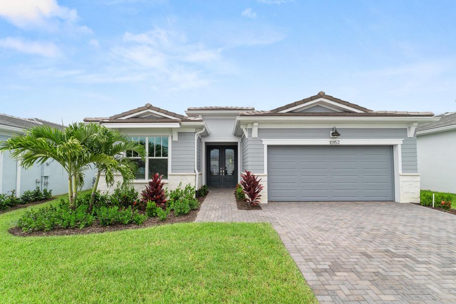 Front exterior of a new home in Tradition - Telaro, Port St. Lucie, FL, highlighting curb appeal (Image 1). Front exterior of a new home in Tradition - Telaro, Port St. Lucie, FL, highlighting curb appeal (Image 1).