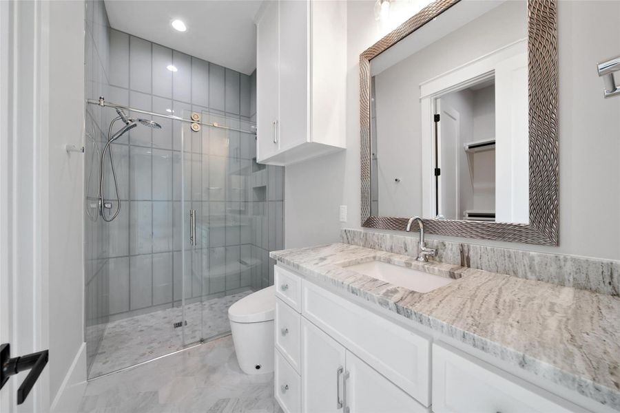 Downstairs Secondary Bathroom ensuite is just as luxurious as the primary.  Complete with walk-in closet and custom designed shelving.