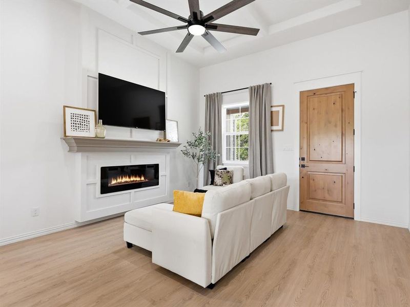 This living room with coffered ceilings and natural light is welcoming to all!